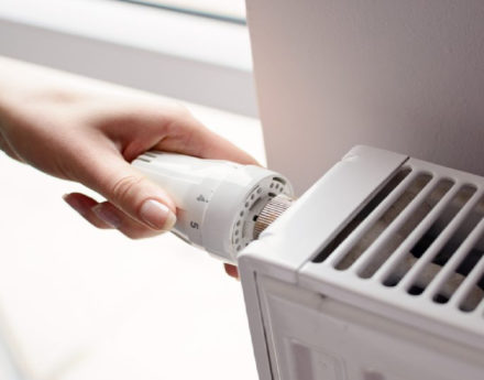 Person adjusting radiator