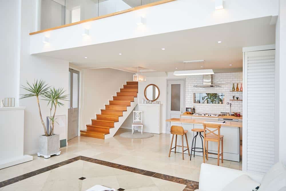 very modern duplex apartment including living room stairs, and kitchen